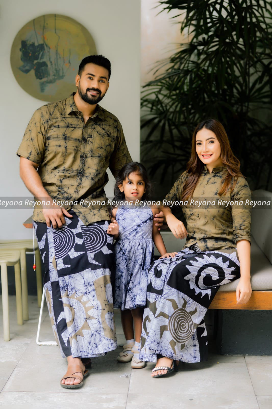 Family wearing handcrafted batik unisex sarong and women’s lungi in natural brown and black designer patterns – Reyona Clothing Australia