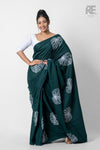 Woman wearing deep green handcrafted cotton batik saree with leaf motifs – Reyona ethnic wear