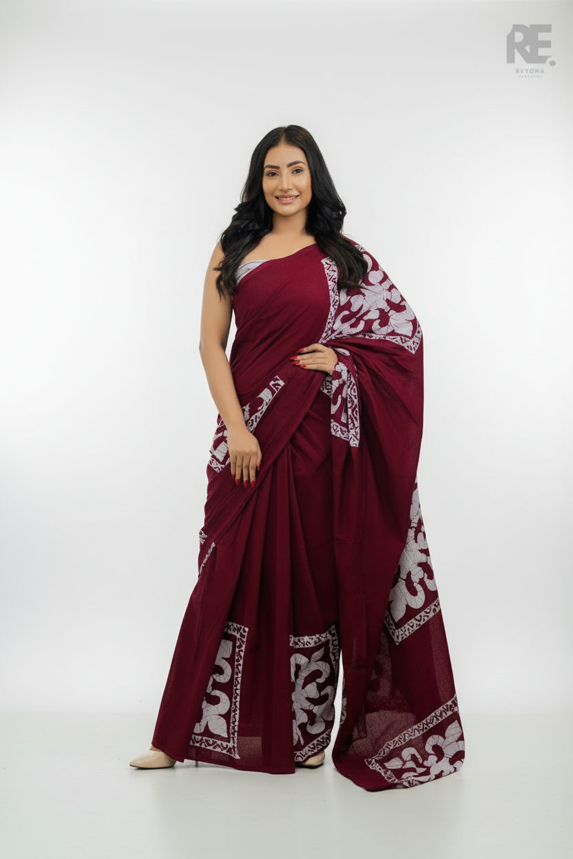 Woman wearing a maroon handcrafted batik saree with white patterned borders — Batik Saree RE-0047 I REYONA Clothing Australia
