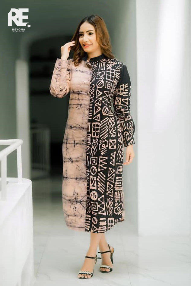 Woman wearing a handmade dual-tone beige and black long batik dress with geometric prints, from Reyona Clothing – RE-0006