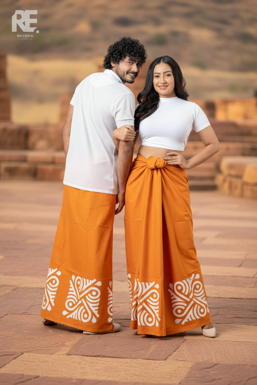 Couple wearing handcrafted orange batik unisex sarong and women’s lungi with white traditional batik art prints – Reyona Clothing Australia