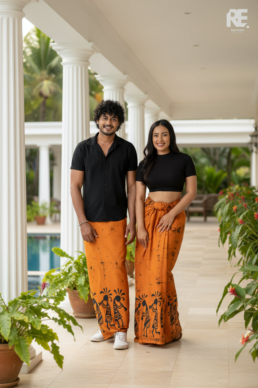 Couple wearing handcrafted orange printed unisex sarong and women’s lungi with black tribal batik art – Reyona Clothing Australia