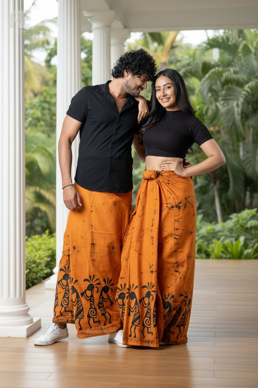 Couple wearing handcrafted orange printed unisex sarong and women’s lungi with black tribal batik art – RE-0081