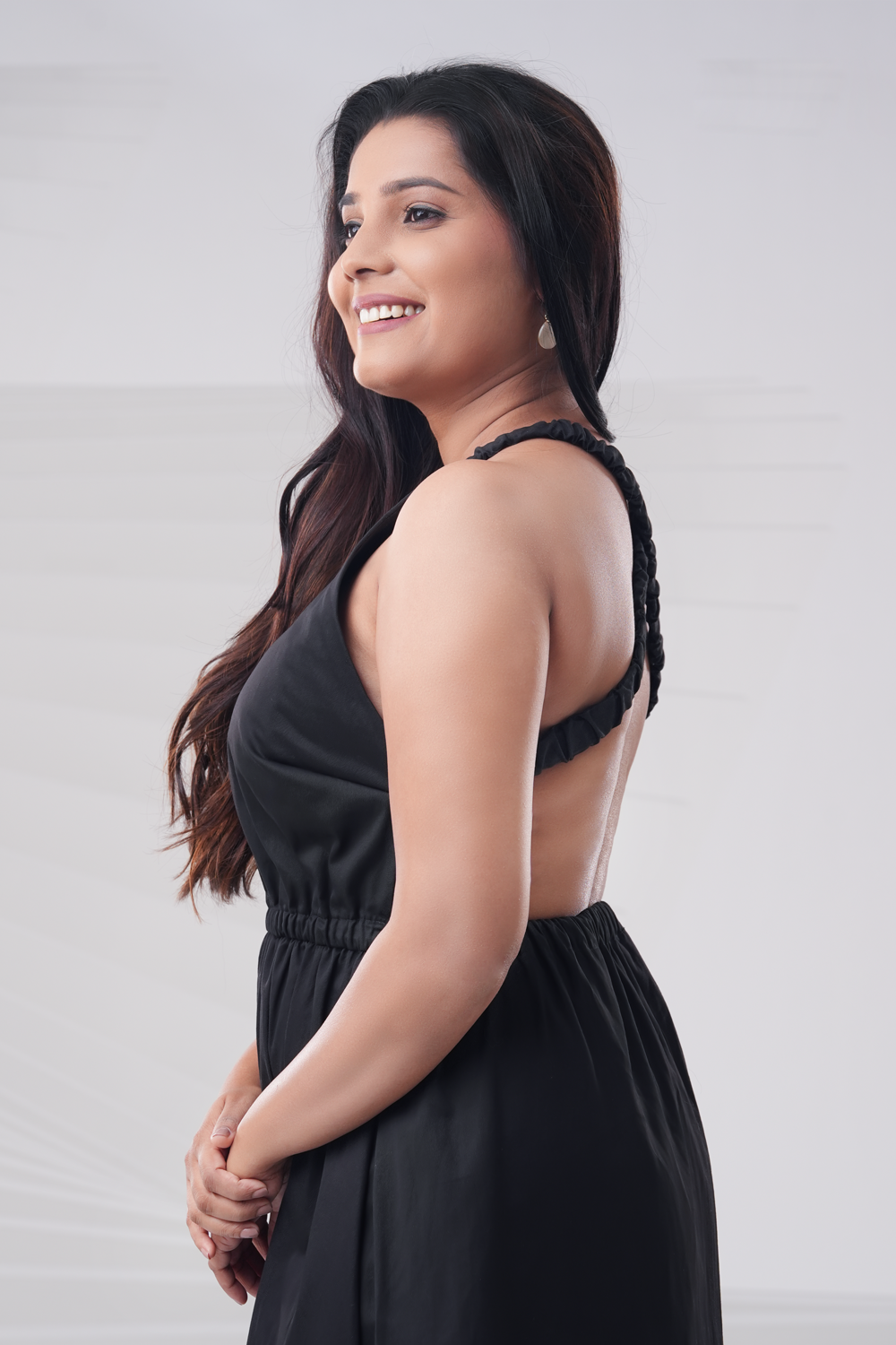 Side view of black cotton maxi dress with cross-back detail