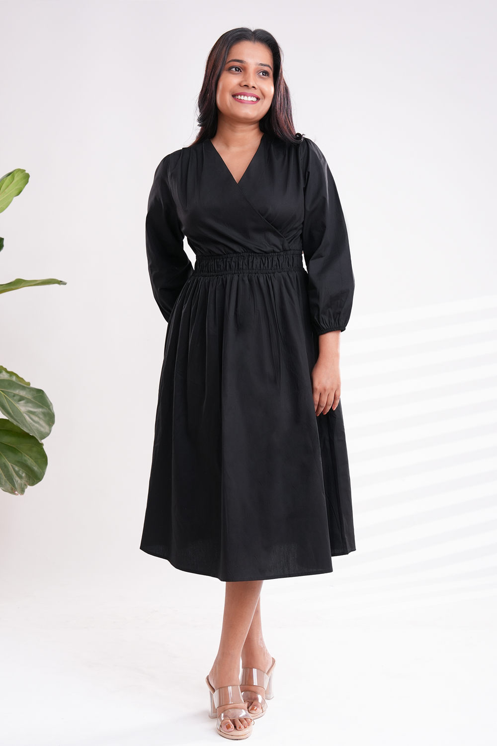 Black midi dress with elegant V-neckline and long sleeves