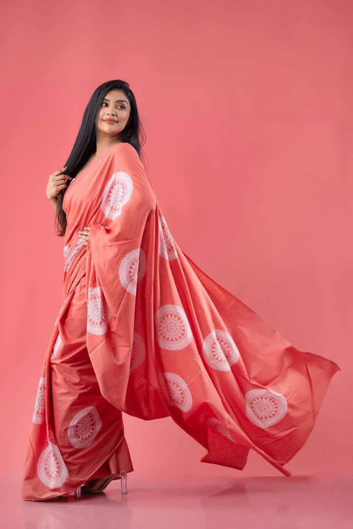 Woman wearing salmon pink handcrafted cotton batik saree – Reyona