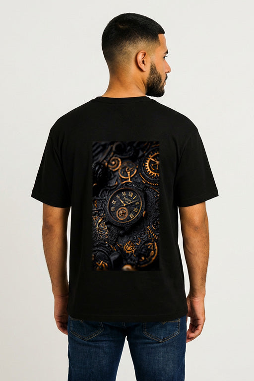 Male model wearing a black graphic T-shirt with a large vintage watch and mechanical gears design on the back.